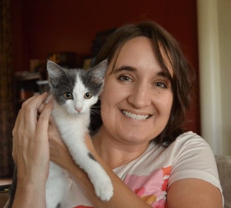 Theresa Venette smiling holding a grey and white kitten