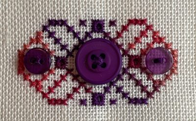 stitched motif with burgundy buttons